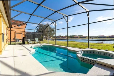 Enjoy sunny days by this private pool and hot tub, enclosed in a screened lanai overlooking a peaceful lake. Perfect for relaxation and outdoor fun!