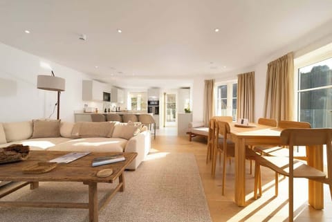 Experience the expansive elegance of our open-plan living room, which is built for comfort and easy relaxation in the centre of your stay.