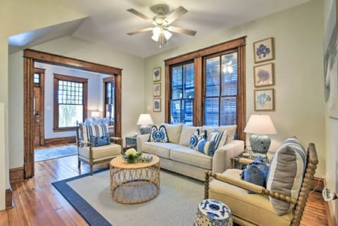 Bright coastal living room with historic charm and warm wood trim
