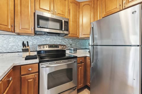 Kitchen: Main floor, drip coffee maker, toaster, cooking utensils, tableware