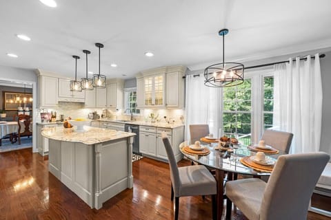Updated modern kitchen with island and dining area.