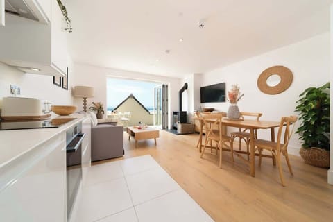 Experience the expansive elegance of our open-plan living room, which is built for comfort and easy relaxation in the centre of your stay.