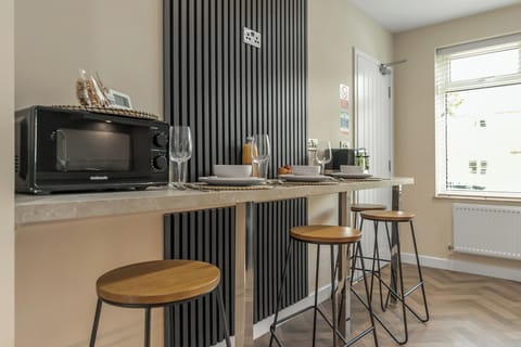 This is the breakfast bar highlighting seats and a microwave for quick meals