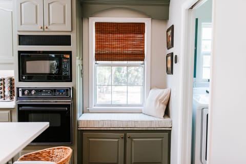 Tucked right between the kitchen and laundry, this cozy little bench is perfect for morning coffee, cookbook browsing, or just soaking in the sunshine.