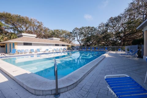 Relax and refresh at this beach stay's crystal-clear pool, surrounded by ample lounge seating—perfect for soaking up the sun before or after your stroll to the nearby sandy shores.