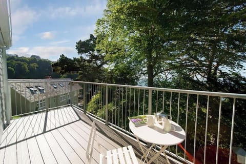 Relax on a peaceful balcony nestled in the treetops, with tranquil views and the sounds of nature all around.