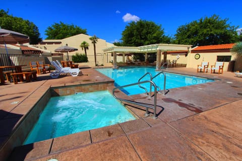 Outdoor pool with covered pergola — cool off after a day at Pioneer Park or Snow Canyon