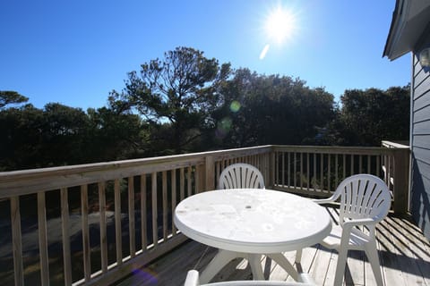 The sunny private balcony is a delightful space for morning coffee or afternoon relaxation amidst the natural beauty of Duck, NC.