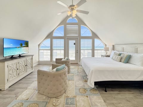 The primary king suite boasts a smart TV, ensuite, & ocean-view balcony​