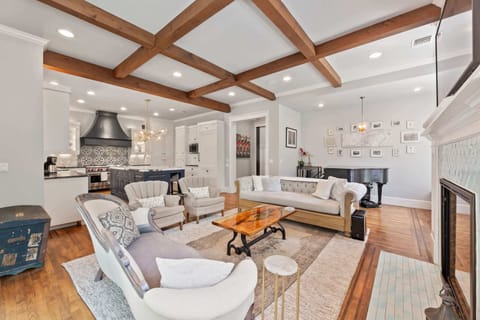 Warm & inviting living room with fireplace, smart TV and piano