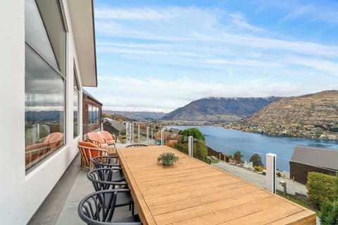 An expansive outdoor dining area with uninterrupted views over Lake Wakatipu and the surrounding mountains—perfect for alfresco meals and sunset drinks.