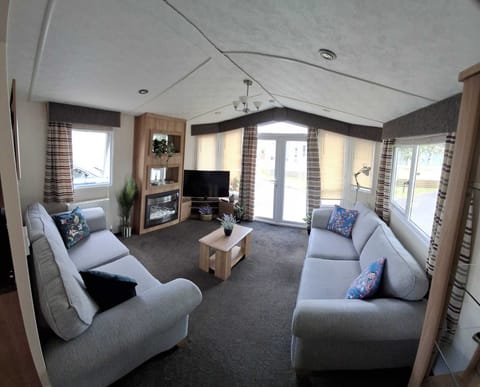 Spacious airy Lounge with French Doors and widescreen TV.