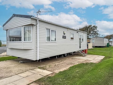 Cozy mobile home with bright bay window and open lawn