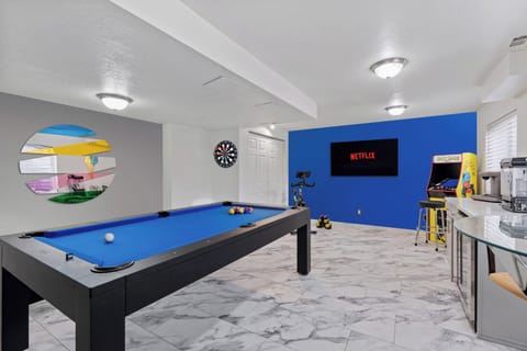 Pool table, classic Pac Man, arcade, dart board, Popcorn machine.