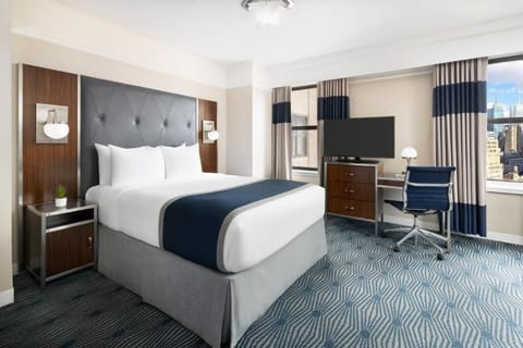 Recharge at bedside with warm lamps and tidy nightstand storage.