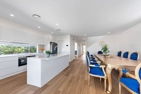 Cook, dine, and entertain in a space that fuses coastal light with regal charm.