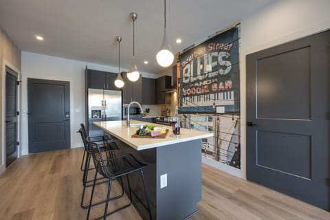 Unit 1: Fully equipped kitchen stocked with your basic cooking essentials. Includes stainless steel appliances, kitchen island, coffee machine, and toaster.