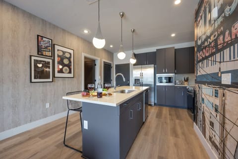 Unit 1: Fully equipped kitchen stocked with your basic cooking essentials. Includes stainless steel appliances, kitchen island, coffee machine, and toaster.