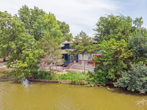 Modern lakefront home with a private deck—relax and enjoy scenic water views surrounded by beautiful trees