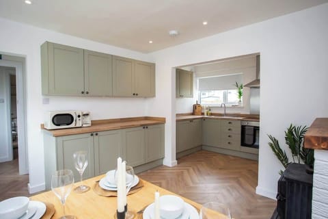 Spacious kitchen with modern appliances, ample storage, and warm wooden accents