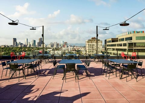 Rooftop seating with city skyline views and open skies
