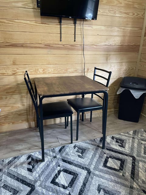 Entry area with a table for two and tv.