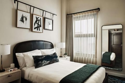 Unwind in crisp linens beneath art-filled, sunlit windows.