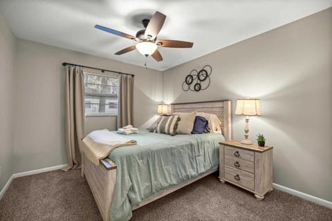 Cozy bedroom with soft lighting, plush pillows, and calming green tones—perfect for restful nights.