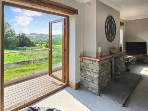 Make the most of those fantastic views from the lounge, leading out onto the balcony | Meadowview Barn, Halfpenny, near Kendal