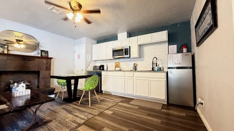 Cook, reheat, or brew — this kitchen has a microwave, fridge, and all the basics for an easy meal at home.