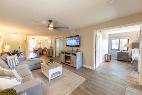 Spacious open-concept living with beach-inspired decor, smart TV, and dining for six. Relax after a day of sun, surf, and seaside adventures in this cozy vacation rental retreat.