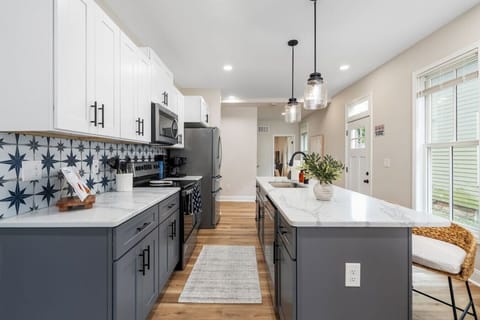 Modern kitchen with granite counters, stainless appliances, and generous prep space.
