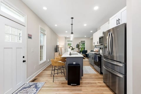 Open kitchen layout with island seating and sightlines into the living area.