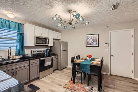 A clean, well-equipped kitchen featuring ample counter space, essential cookware and utensils, and a dedicated coffee area.