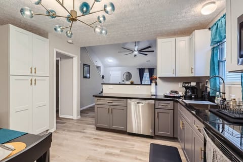 A stylish, fully equipped kitchen with quality utensils, sleek countertops, and a coffee setup designed for everyday comfort.