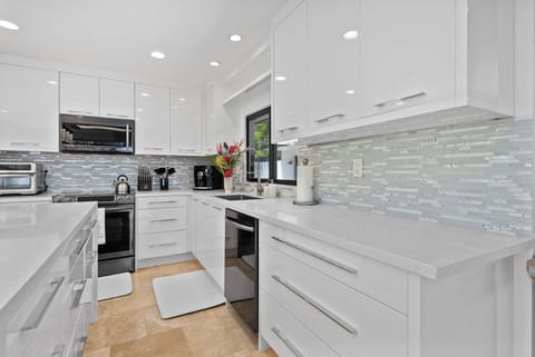 Everything at your fingertips—modern layout and streamlined convenience in the Honolulu Lagoonfront Villa kitchen.