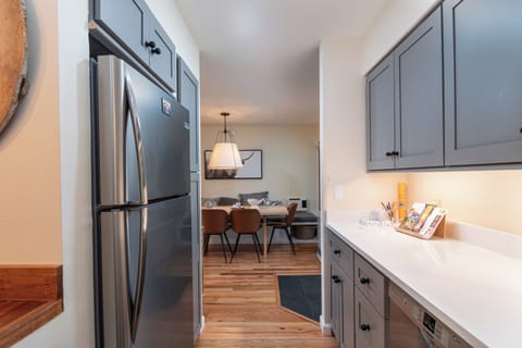 - Galley style kitchen with sleek cabinetry   - Stainless steel refrigerator and full amenities   - Designed for convenience and home style meals