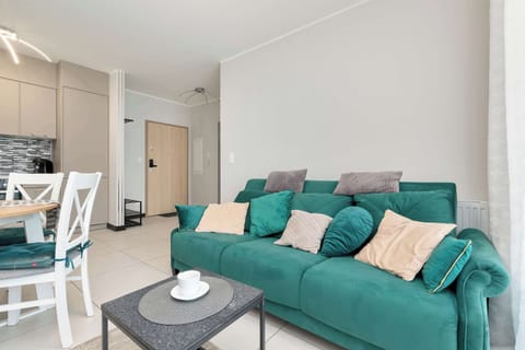 The carefully designed interior with a soft sofa, subtle details, and dining area offers a cozy atmosphere and comfort.