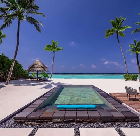 Dive into your beachfront plunge pool under endless blue skies.
