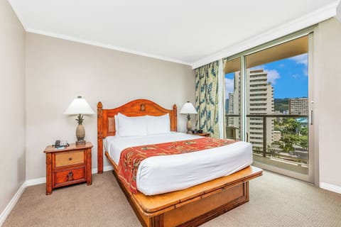 Unwind in a serene king bedroom with city views.