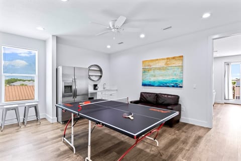 3rd Floor - Game room with ping-pong table, lounge seating, and kitchenette with a full fridge/freezer, ice maker, and a sink