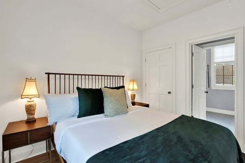 Queen bed with soft linens + peaceful treetop views.