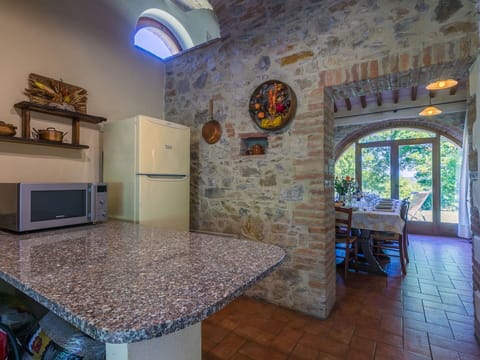 Flooring, Furniture, Ceiling, Kitchen & Dining Room Table, Countertop, Chair, Brick, Stone Wall, Houseplant, Kitchen