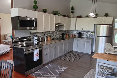 A large kitchen. Plenty of counter space and many appliances. 