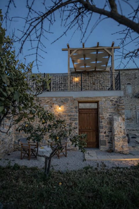 Traditional Stone House Exterior with Warm Evening Lighting