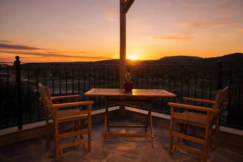 Outdoor Dining Area with Wooden Pergola and Sunset Views
