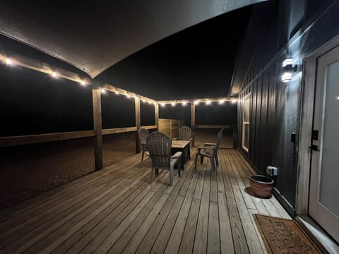 Extra large porch with privacy screens, fire table and seats for cold nights
