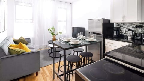 Modern kitchen, dining, and lounge space with seating for six