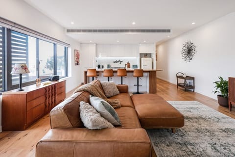 Spacious open-plan living and dining with warm natural tones
