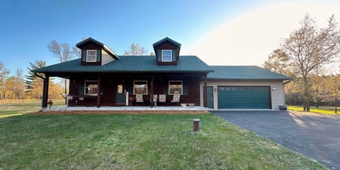 Relax on the large covered porch with many cushioned chairs and a double hammock